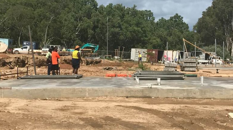 Three Indigenous construction workers on a construction site on Palm Island.