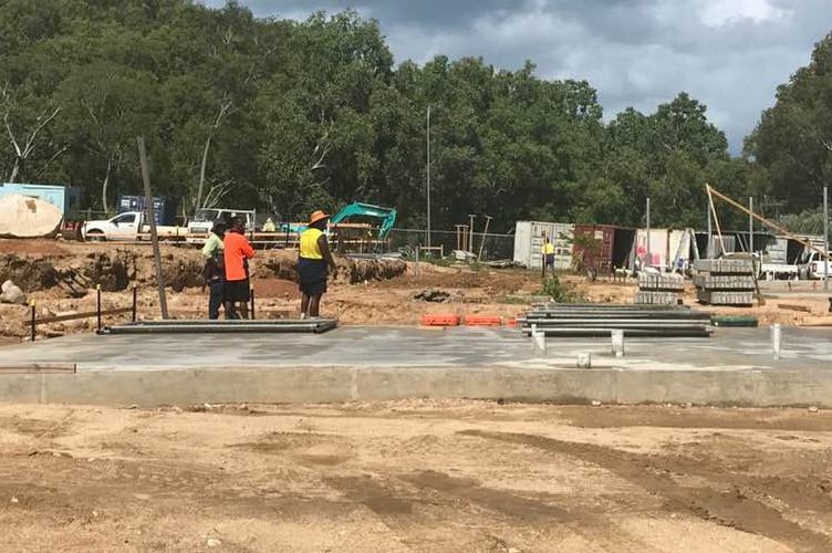 Three Indigenous construction workers on a construction site on Palm Island.