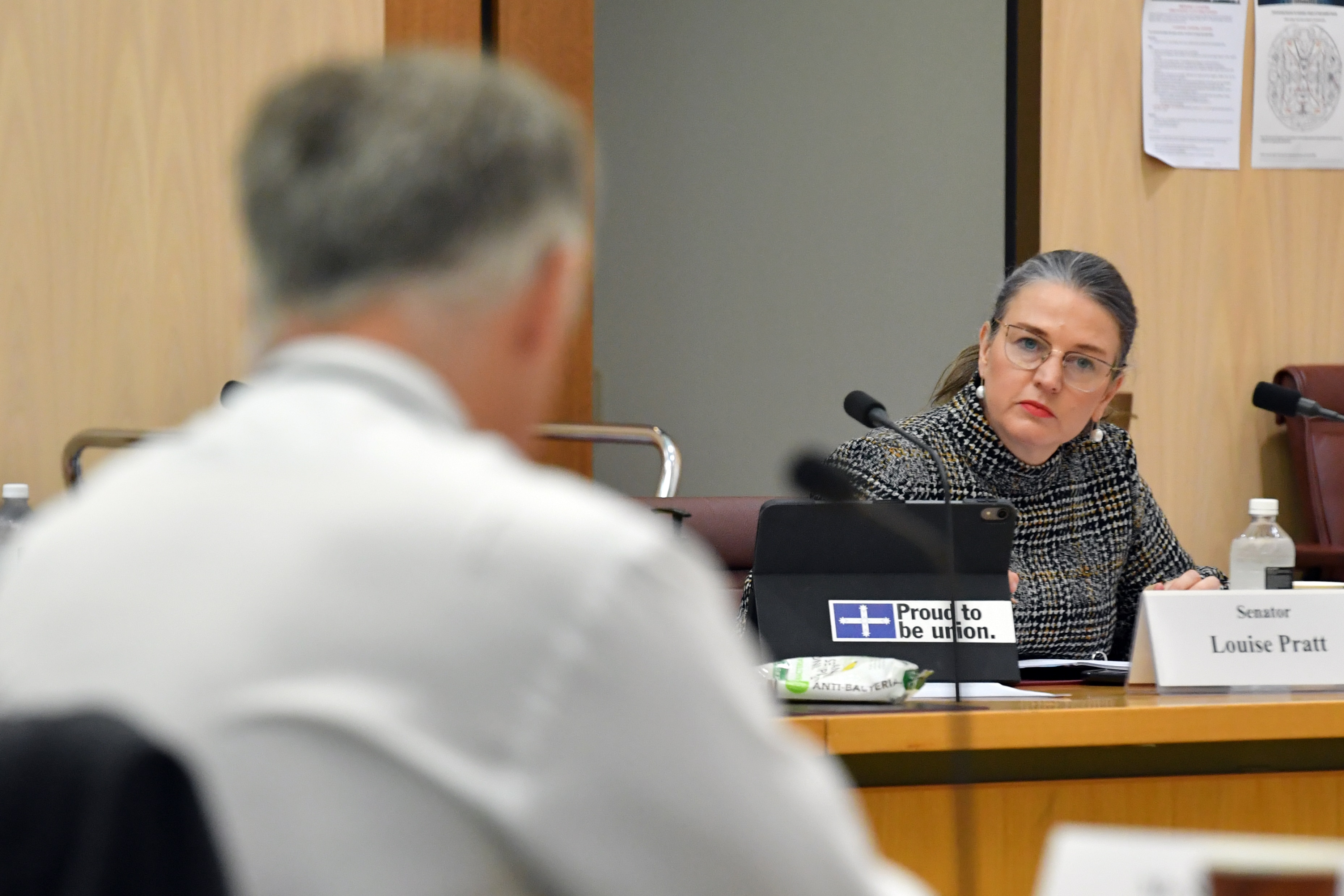 A woman looks inquisitively at a man.