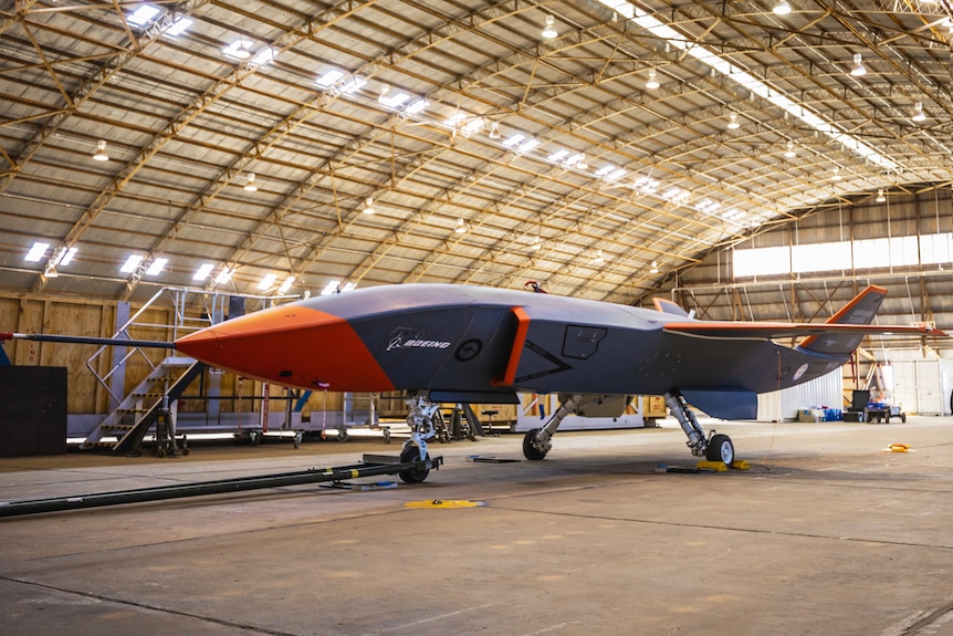 Boeing  Loyal Wingman plane in large hangar.