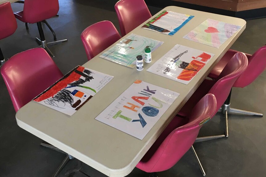 Children's placemats adorn volunteer dining tables
