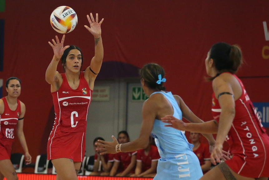 A Tongan player passes the ball during a Netball World Cup game against Fiji.