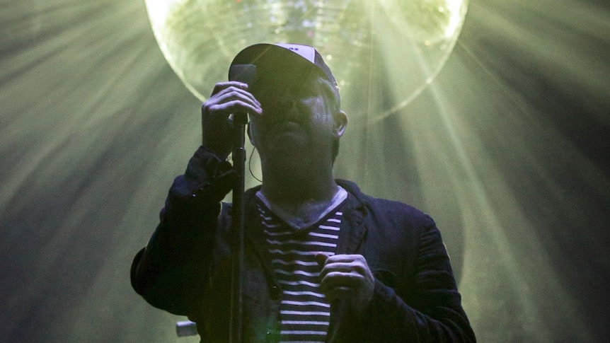 James Murphy under a glowing disco ball at LCD Soundsystem's headline Splendour In The Grass 2017 set