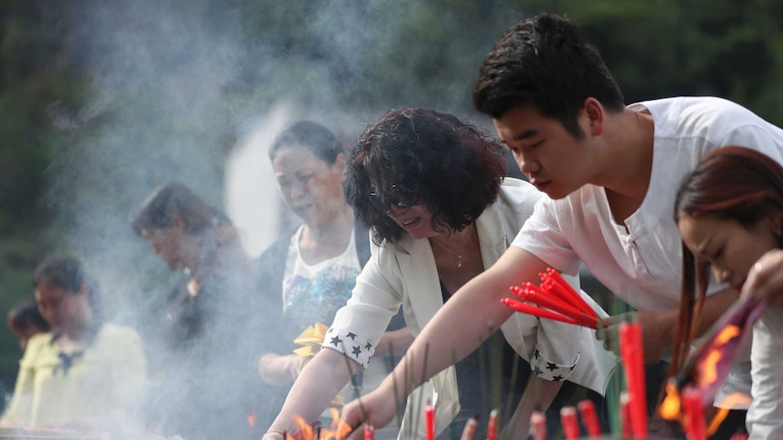 People burn candles and incense as they mourn in Beichuan in southwestern China's Sichuan province.