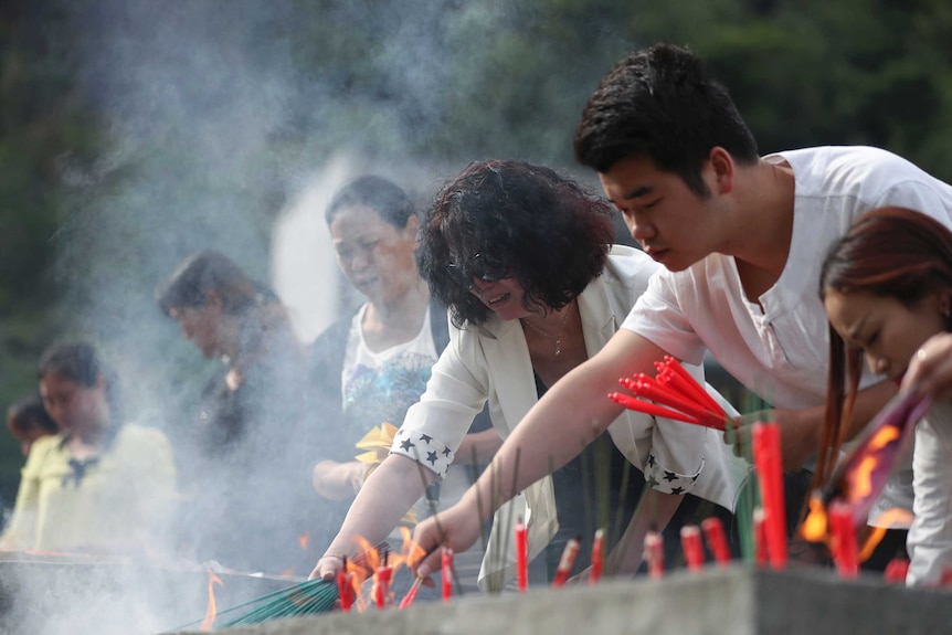 People burn candles and incense as they mourn in Beichuan in southwestern China's Sichuan province.