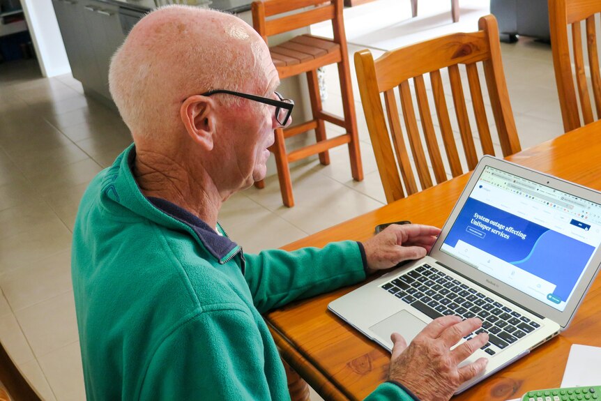 a bald man looks at a website