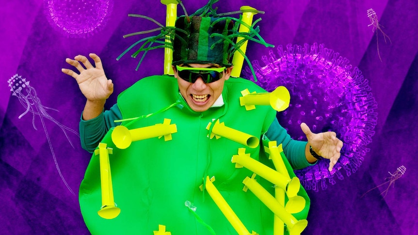 A person in a strange looking costume representing a virus while illustrated viruses float in the backgound.