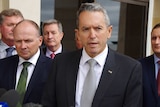 Nationals Leader Terry Redman stands with other Nationals members in front of Parliament.