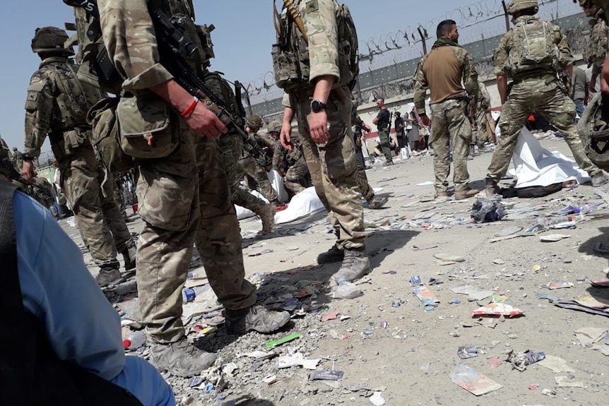 An image of foreign soldiers covering bodies of people who died at Kabul airport