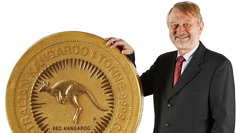 Perth Mint CEO Ed Harbuz stands next to a 1,012kg gold coin worth more than $50 million unveiled by the mint