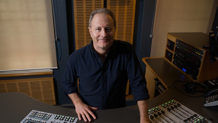 A shot of Craig Hamilton standing in front of the radio desk at ABC Newcastle.