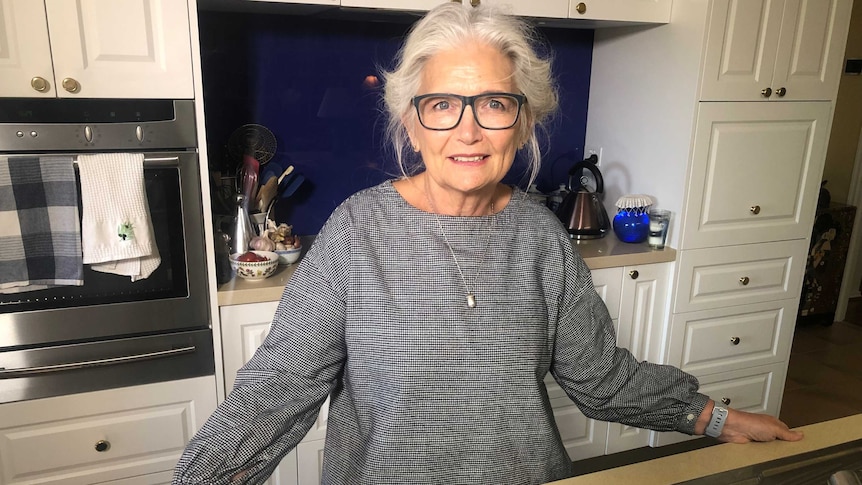 Vickie Hingston-Jones stands in a kitchen, staring calmly into the camera.