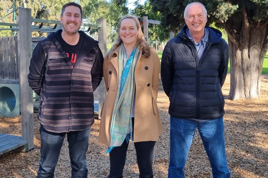 donor siblings and their sperm donor father pose for photo in park