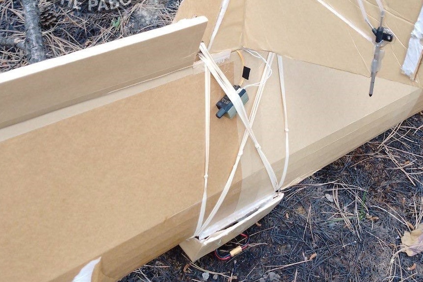A cardboard drone allegedly built in Australia smashed up on the ground in Russia