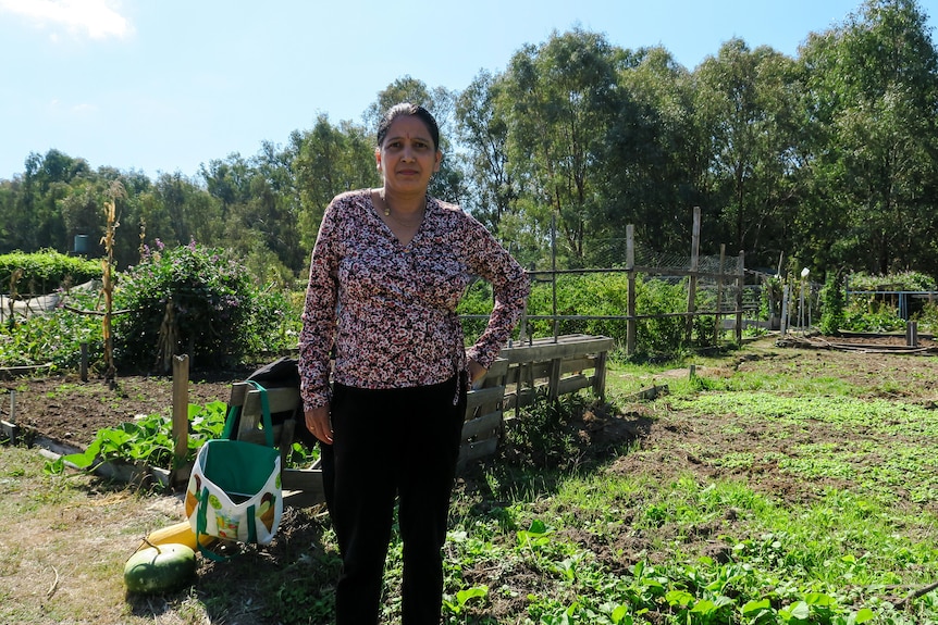 Bhakti stands in front of her crop at the community farm.