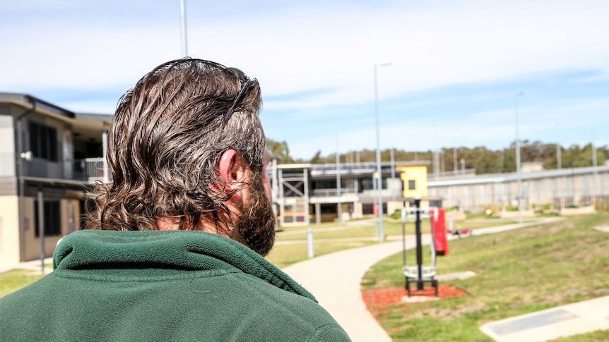 Prisoner walks through prison grounds