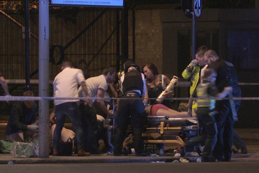 People receive medical attention in Thrale Street near London Bridge.