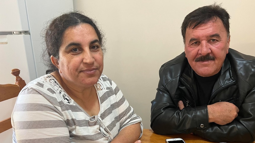 A woman and man sit at a table together 