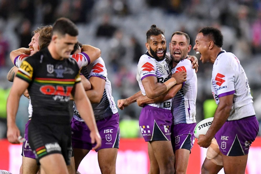 Cameron Smith and Josh Addo-Carr huge each other