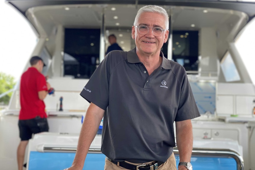 Riviera Director Stephen Milne standing on the back of a yacht that's nearing completion.