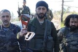 Syrian Turkmen rebels show off part of a Russian airman's parachute