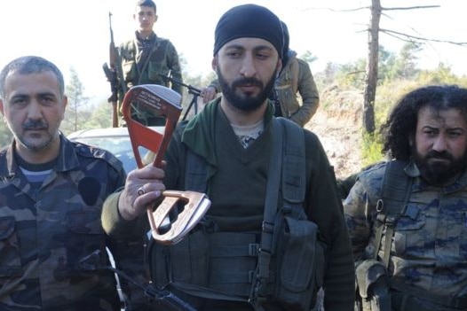Syrian Turkmen rebels show off part of a Russian airman's parachute
