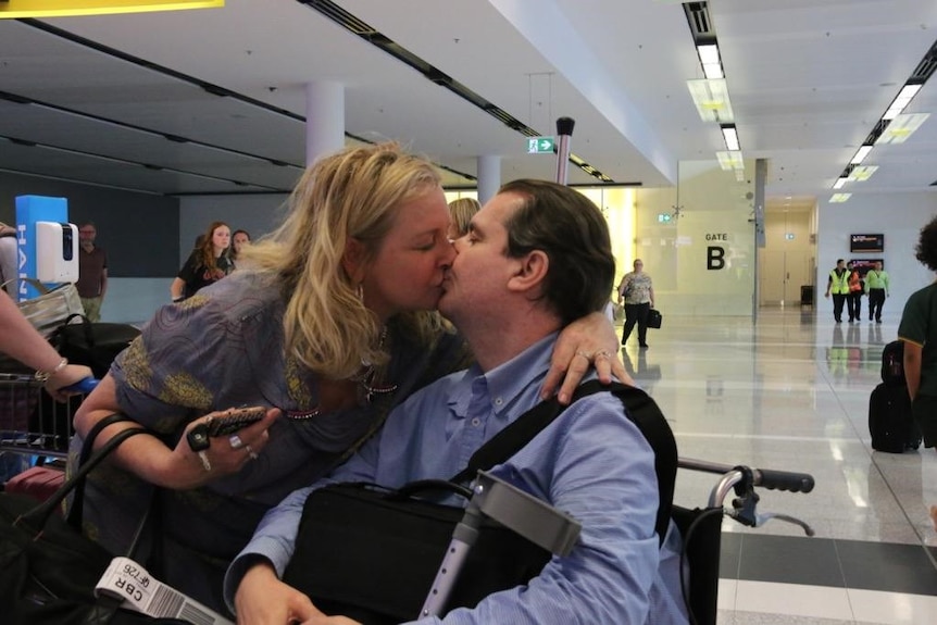 Anthony and Desiree kiss at the arrivals gate