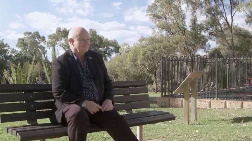 Allan Connelly sitting at a park bench