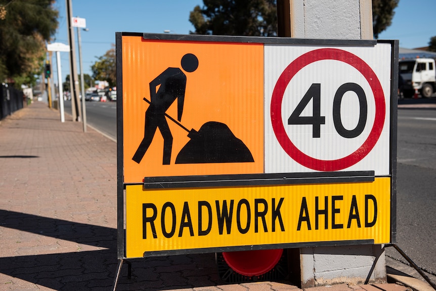 A temporary sign saying Roadwork Ahead and a 40 kph speed limit.