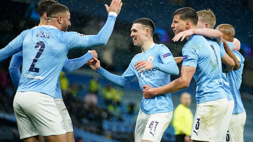 Manchester City players, including Phil Foden and Kyle Walker, celebrate a Riyad Mahrez goal