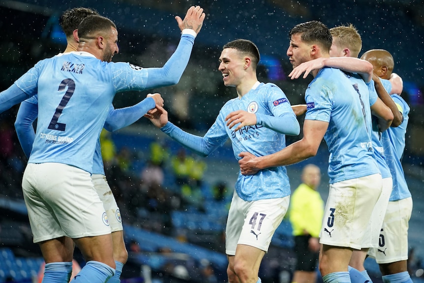 Manchester City players, including Phil Foden and Kyle Walker, celebrate a Riyad Mahrez goal