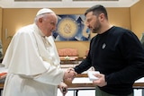 Pope Francis (L) shakes hands with Ukrainian President Volodymyr Zelenskyy.