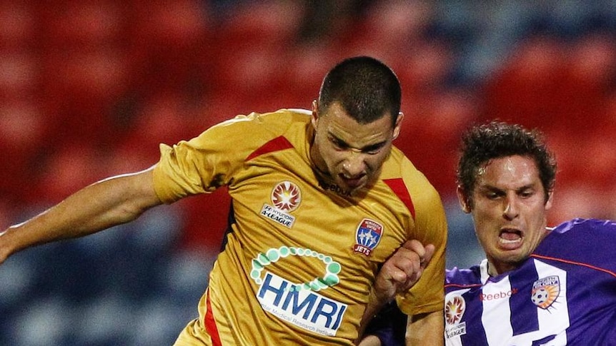 Marko Jesic tries to avoid a challenge from Perth's Josh Mitchell.