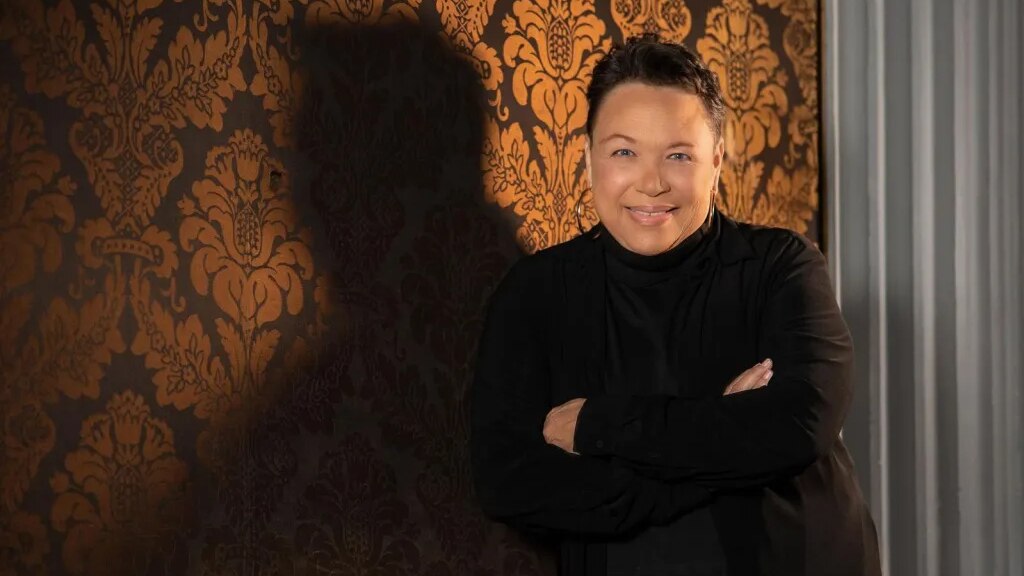 Singer Shawnn Monteiro stands in front of a golden wall