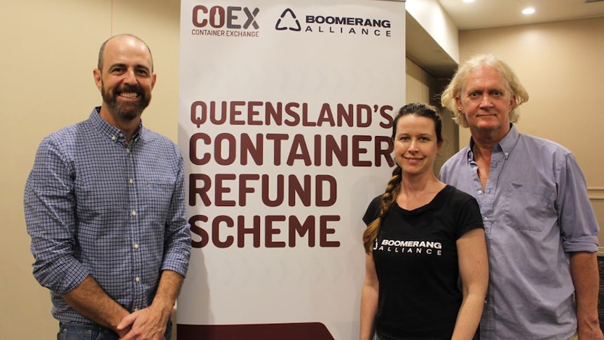 Adam Nicholson from CoEx, Kellie Lindsay and Toby Hutcheon from Boomerang Alliance stand in front of a sign on August 1, 2018.