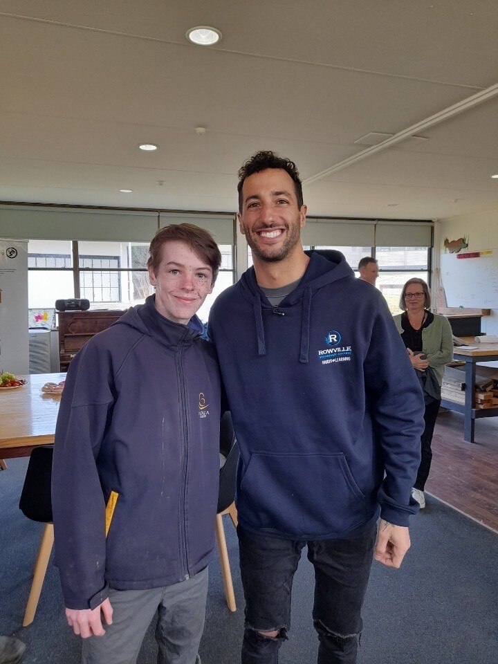 Harper and Daniel standing together and smiling broadly in a classroom.