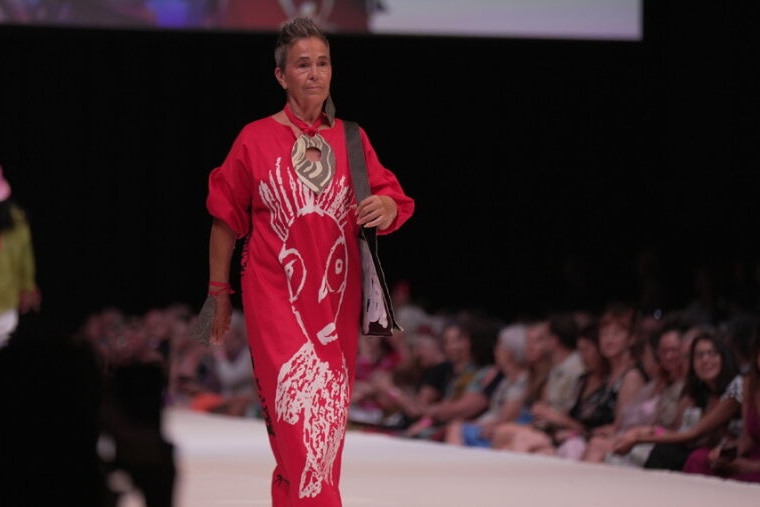 a female model walking in a red dress