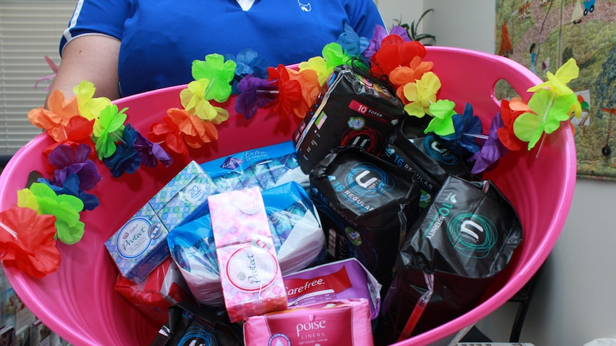 Unused tampons and pads in a bucket.