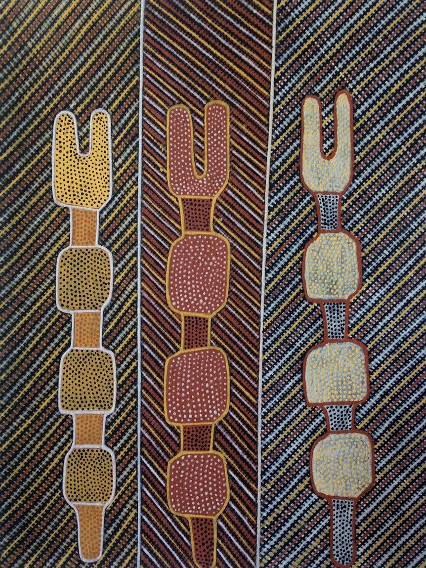An Indigenous painting of finely cross-hatched poles.