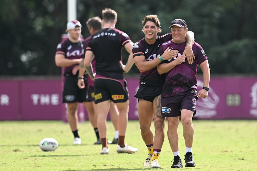 Reece Walsh puts his arm around coach Kevin Walters at Brisbane Broncos NRL training.