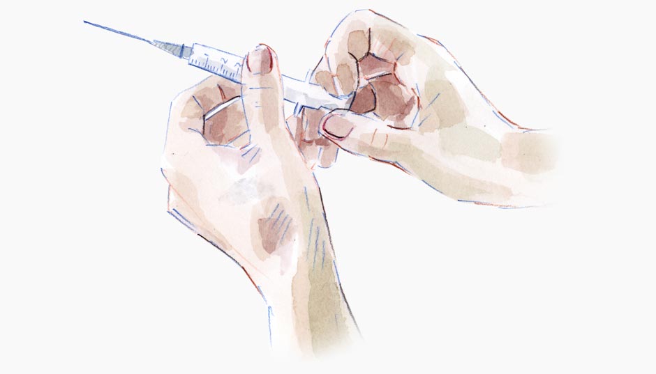 Hands holding a syringe.
