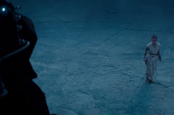 A still from the final Star Wars Episode IX: The Rise of Skywalker trailer with Rey looking at a character off screen.