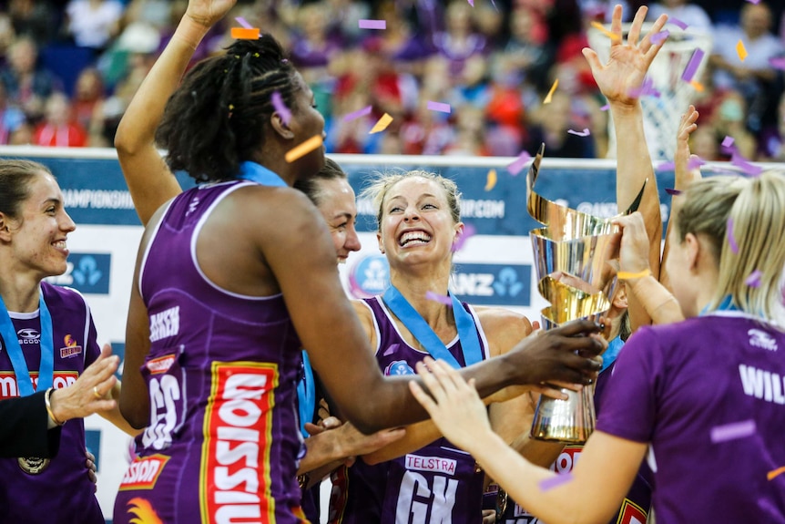 Laura Geitz celebrates with the trans-Tasman netball trophy