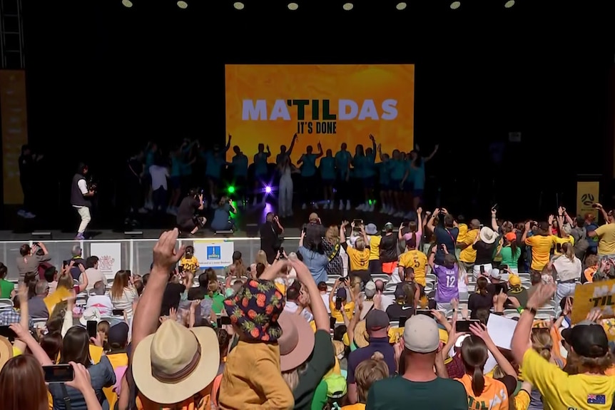 The Matildas dance on stage with Nikki Webster