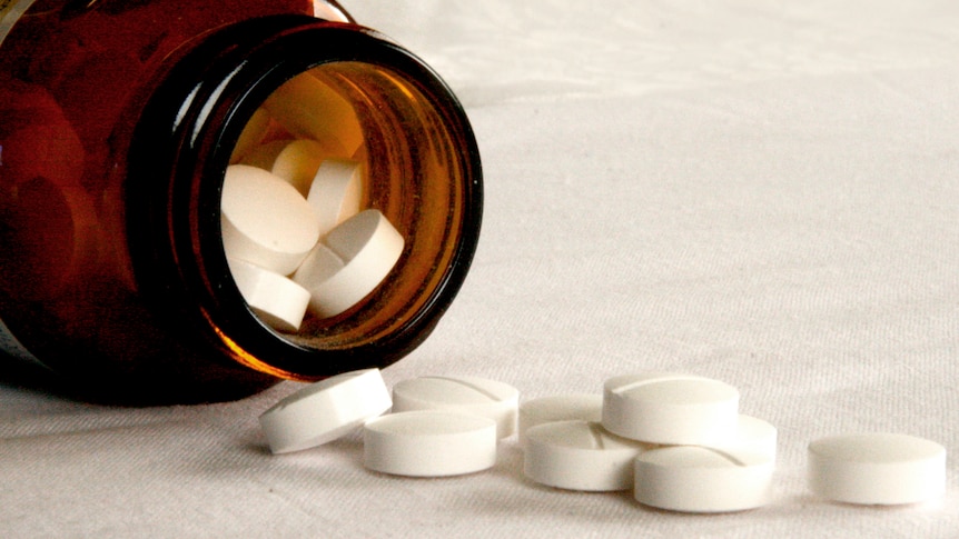 Tablets fall from a jar in Sydney, September 17, 2008.