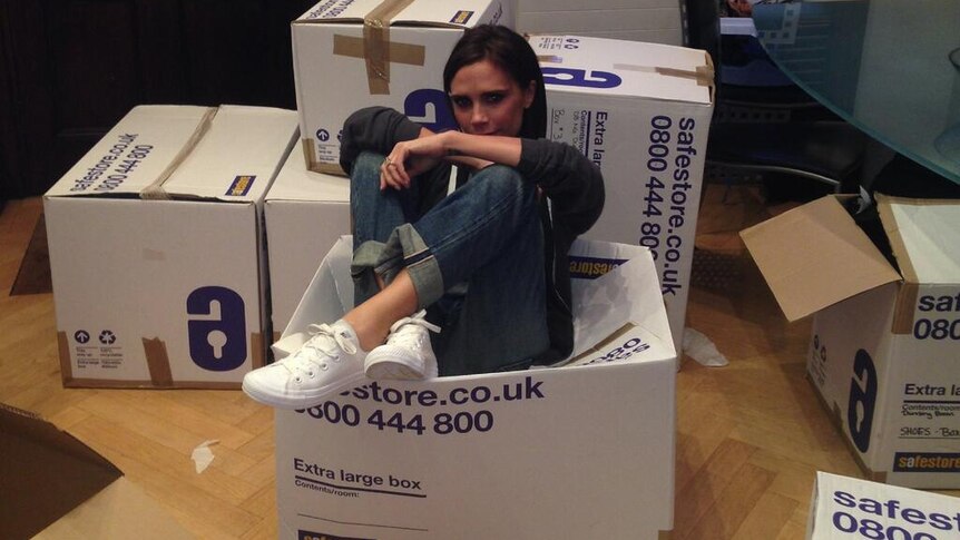 Victoria Beckham sits in box of clothes donated for typhoon relief