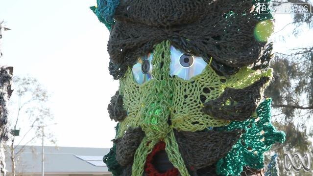 Knitted octopus-like creature made from wool and compact discs