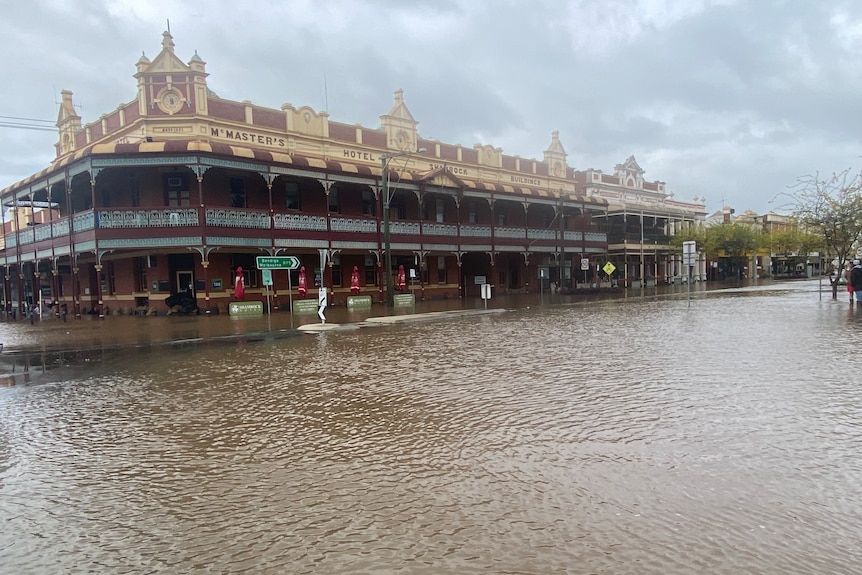 A heritage building surrounded by floodwaters.