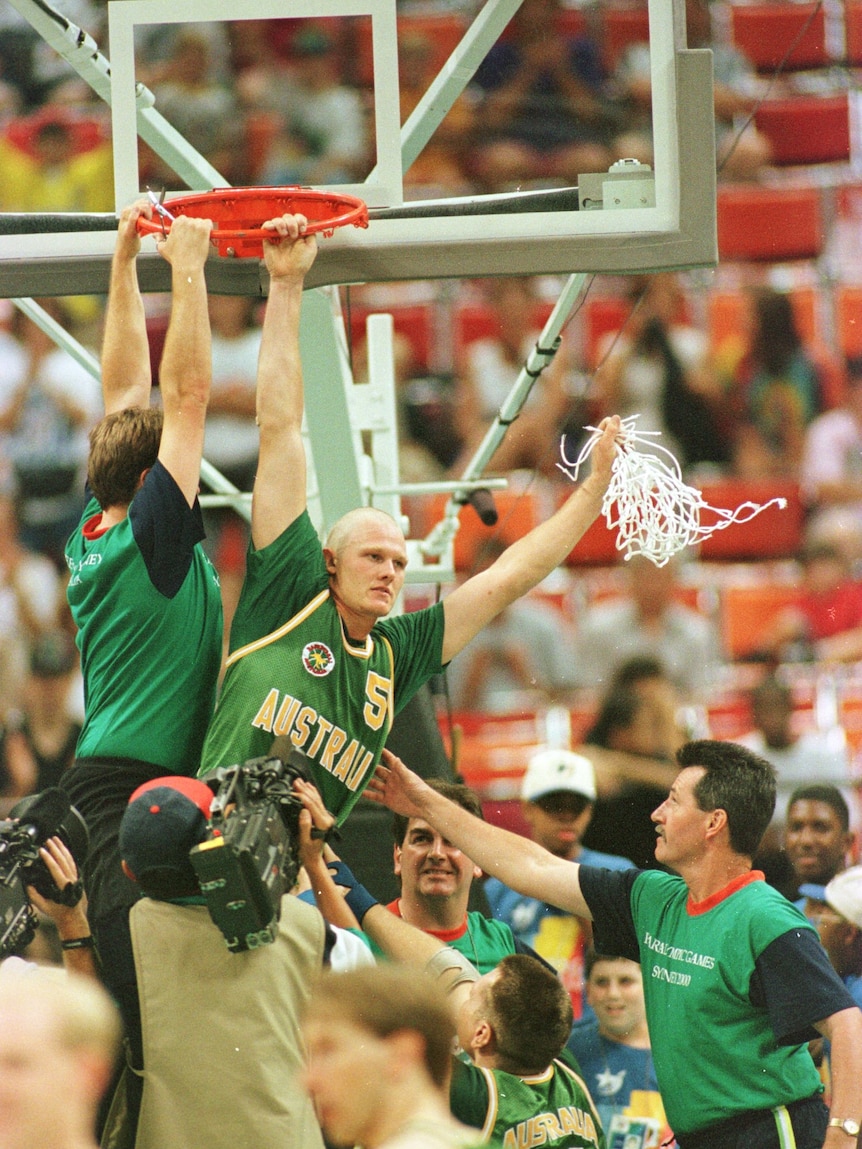 Troy Sachs swinging off the ring at defeating Great Britain in wheelchair basketball at the 1996 Paralympics