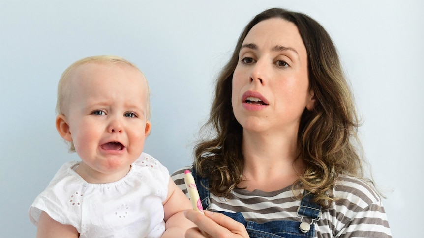 Alison Bell from ABC TV's The Letdown holds a crying toddler